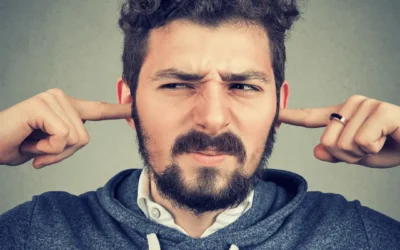 Person covering his two ears because of noise