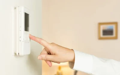 finger reaching the button to turn on thermostat