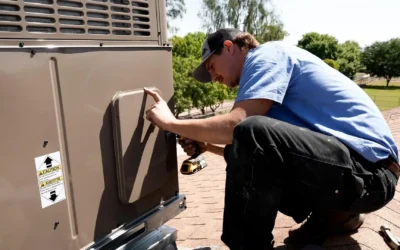 Professional HVAC technician from Falcon Air Conditioning inspecting and maintaining a residential air conditioning unit to improve efficiency and performance.