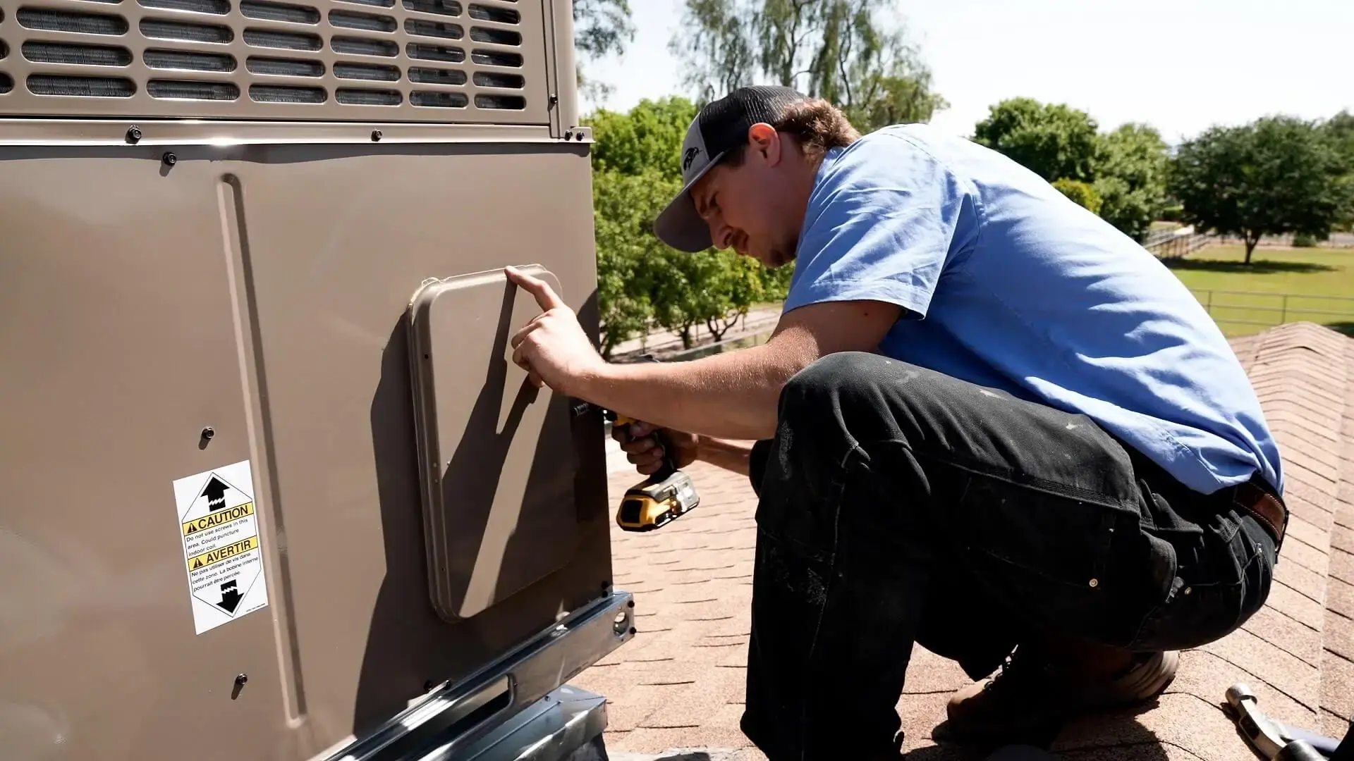 Professional HVAC technician from Falcon Air Conditioning inspecting and maintaining a residential air conditioning unit to improve efficiency and performance.