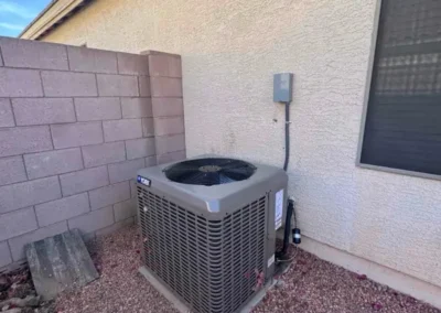 Residential outdoor AC condenser unit installation by Falcon Air Conditioning, providing air conditioning and heating services in Mesa, Arizona.