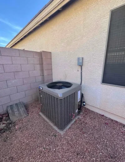 Residential outdoor AC condenser unit installation by Falcon Air Conditioning, providing air conditioning and heating services in Mesa, Arizona.