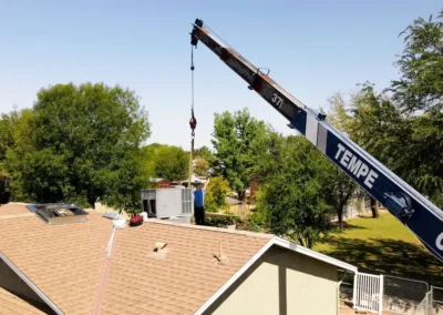 HVAC technicians installing a rooftop AC unit in Mesa, AZ