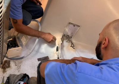 HVAC technicians installing an outdoor AC condenser in Scottsdale, AZ