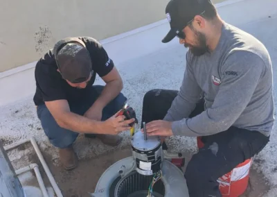 HVAC technicians repairing an outdoor AC system in Mesa, AZ