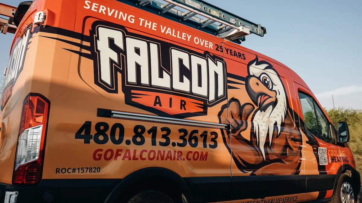Falcon Air Conditioning service van displaying the company logo, phone number, and cooling and heating services