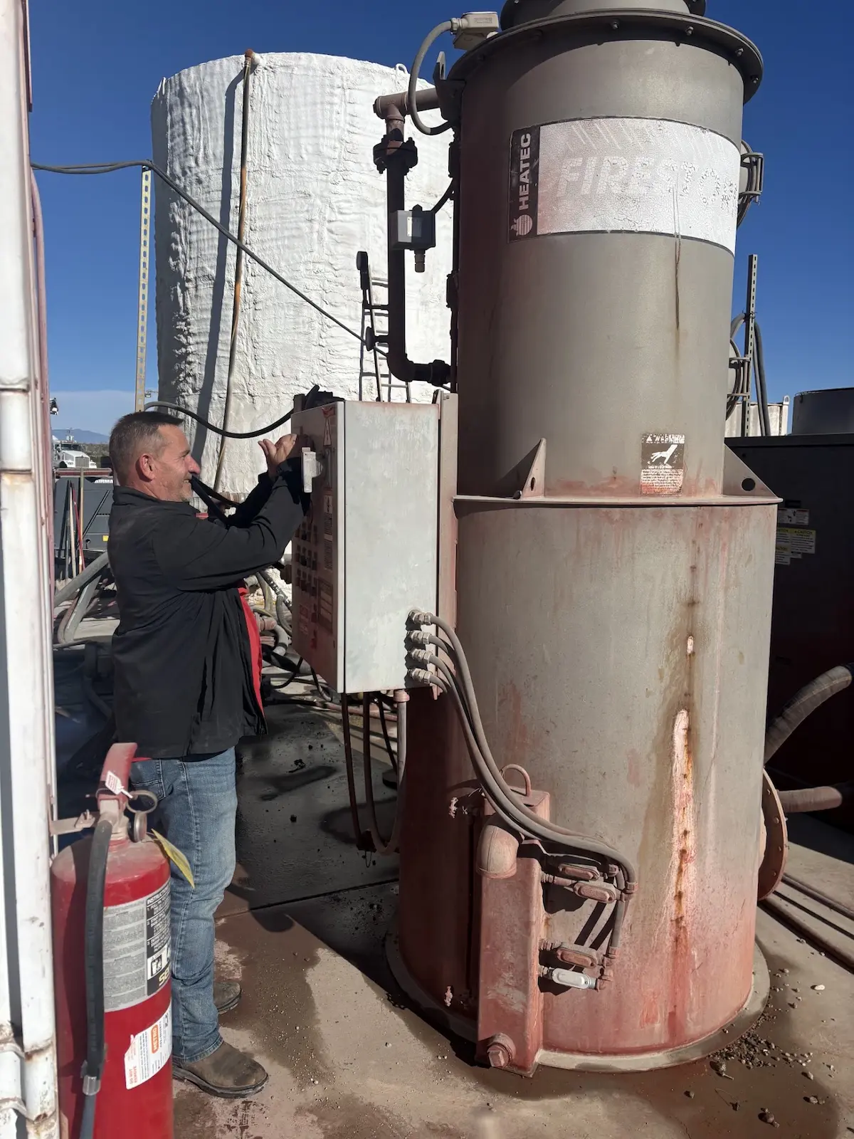 HVAC technician repairing a rooftop heating unit in Mesa, AZ